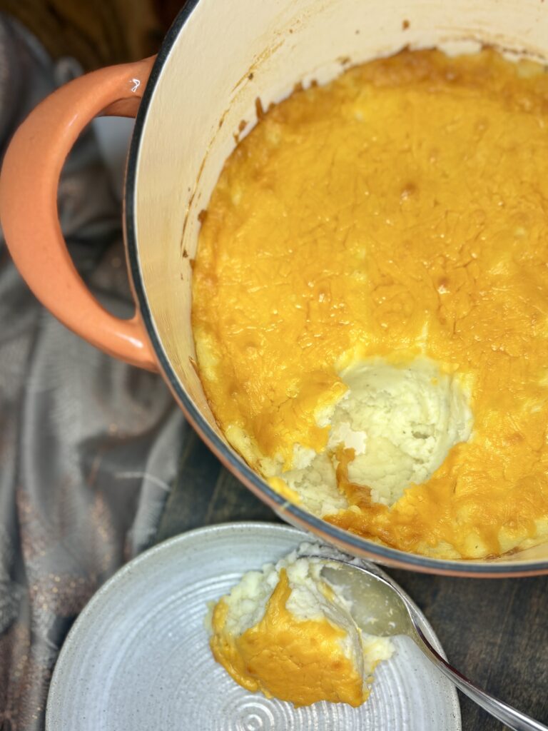 cheesy holiday potatoes scooped onto a plate