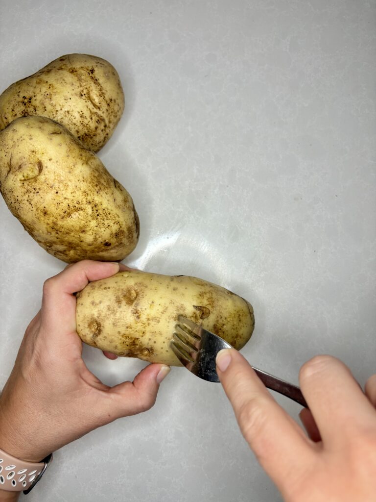 russet potato being pierced with a fork