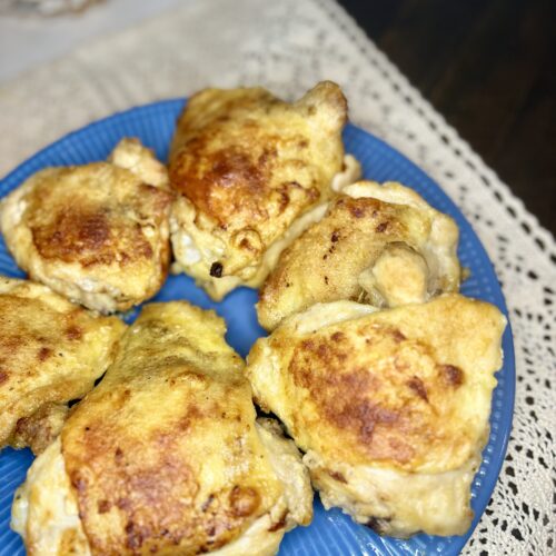 A plate of oven fried chicken thighs