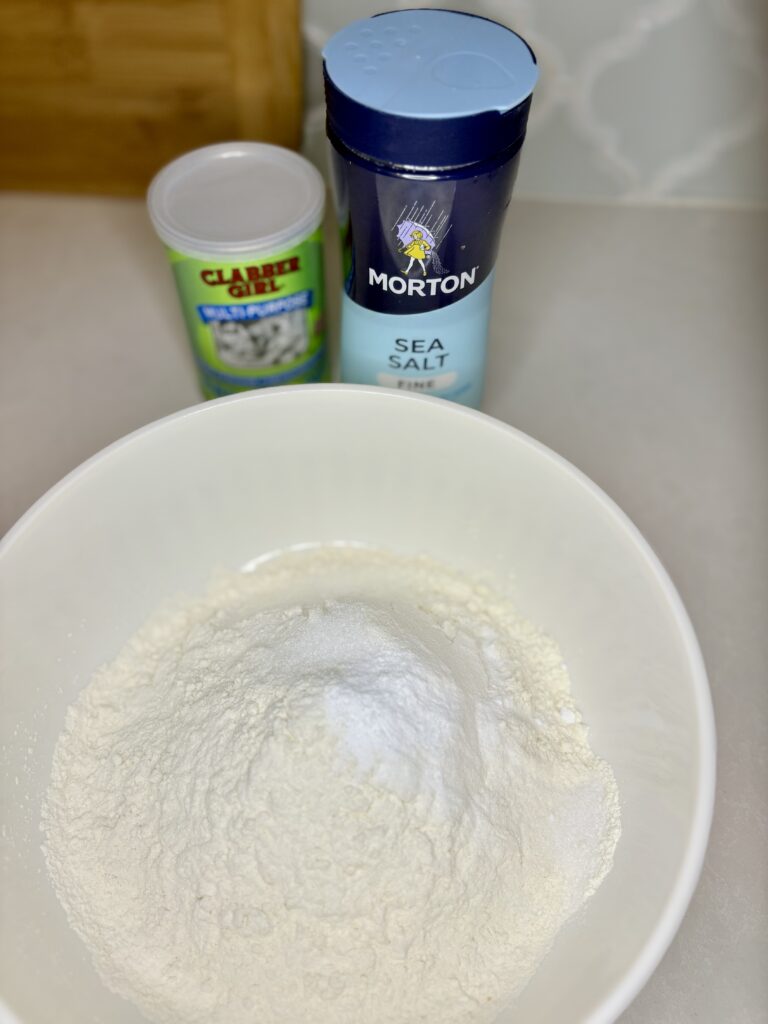 flour, salt, and baking soda in a bowl on a counter