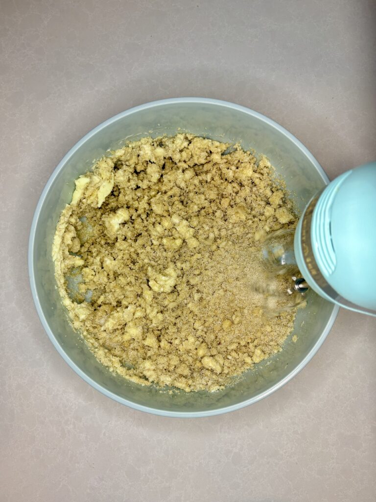 butters and sugars being mixed with a hand mixer in a bowl