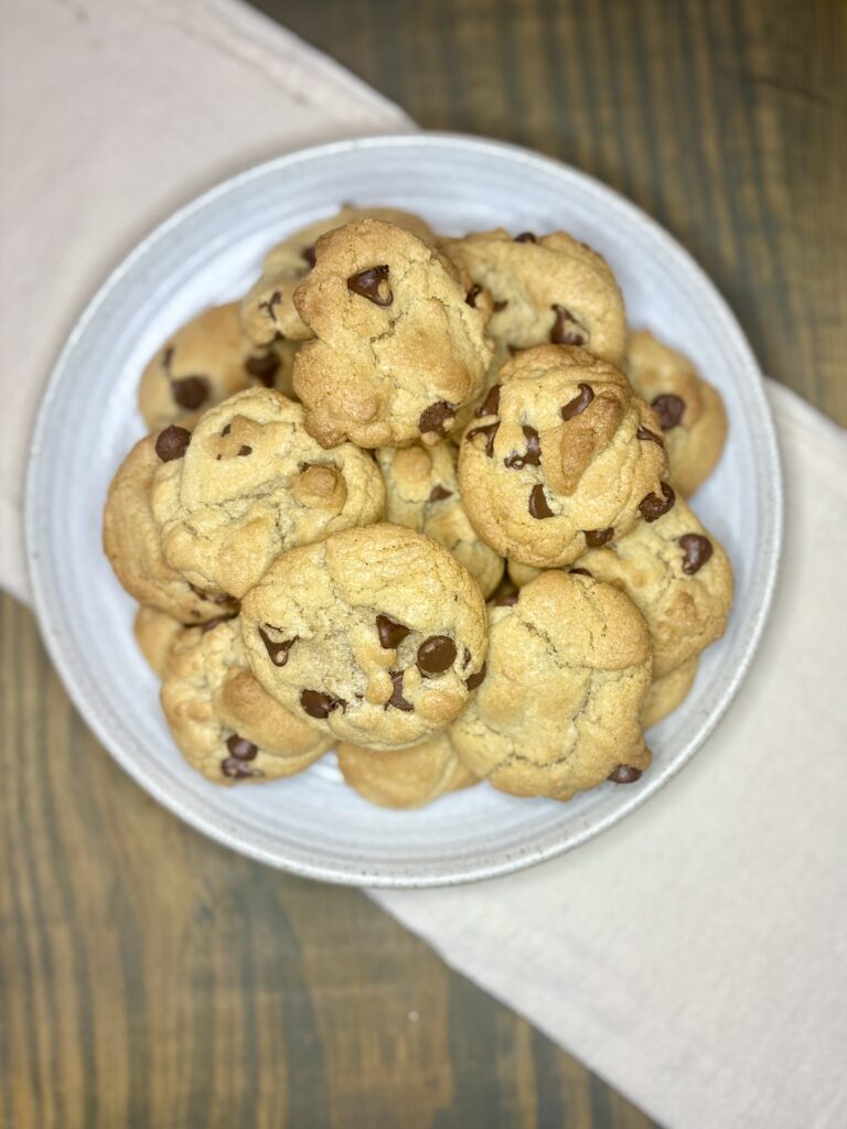 a plate with chocolate chip cookies on a table