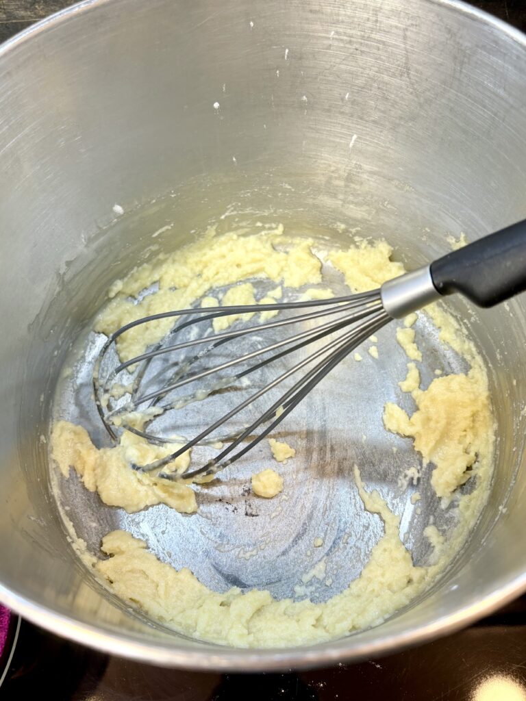 flour and butter being whisked in a pot