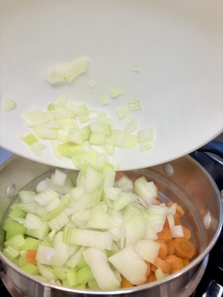 onions being added to the steamer basket