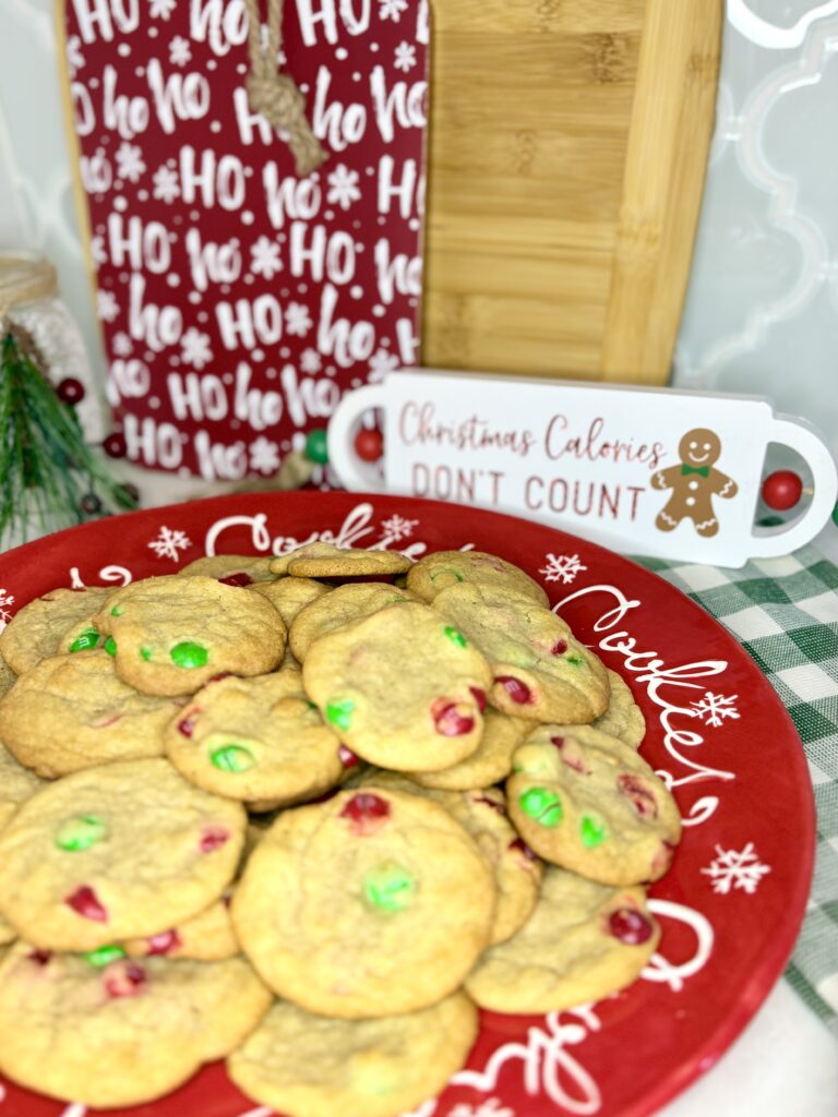 cookies on a platter next to chirstmas decor on a counter