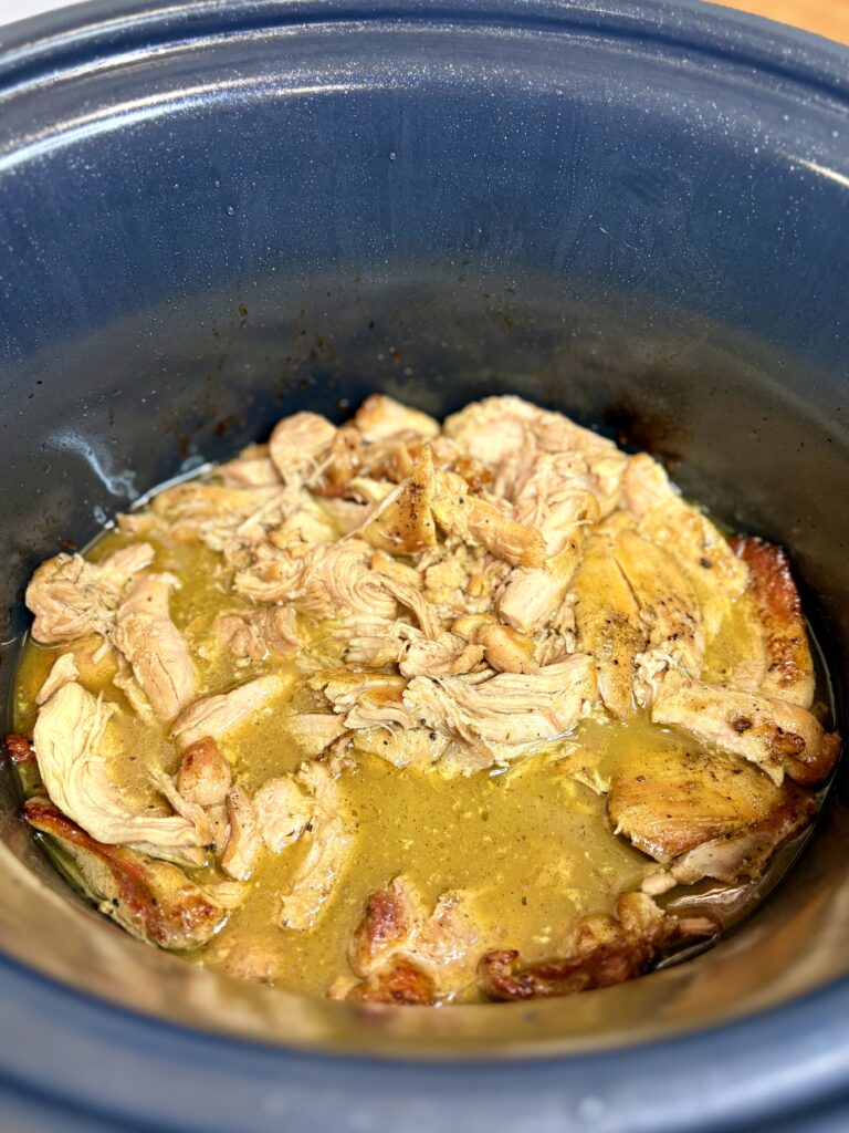 cooked mojo chicken in a slow cooker