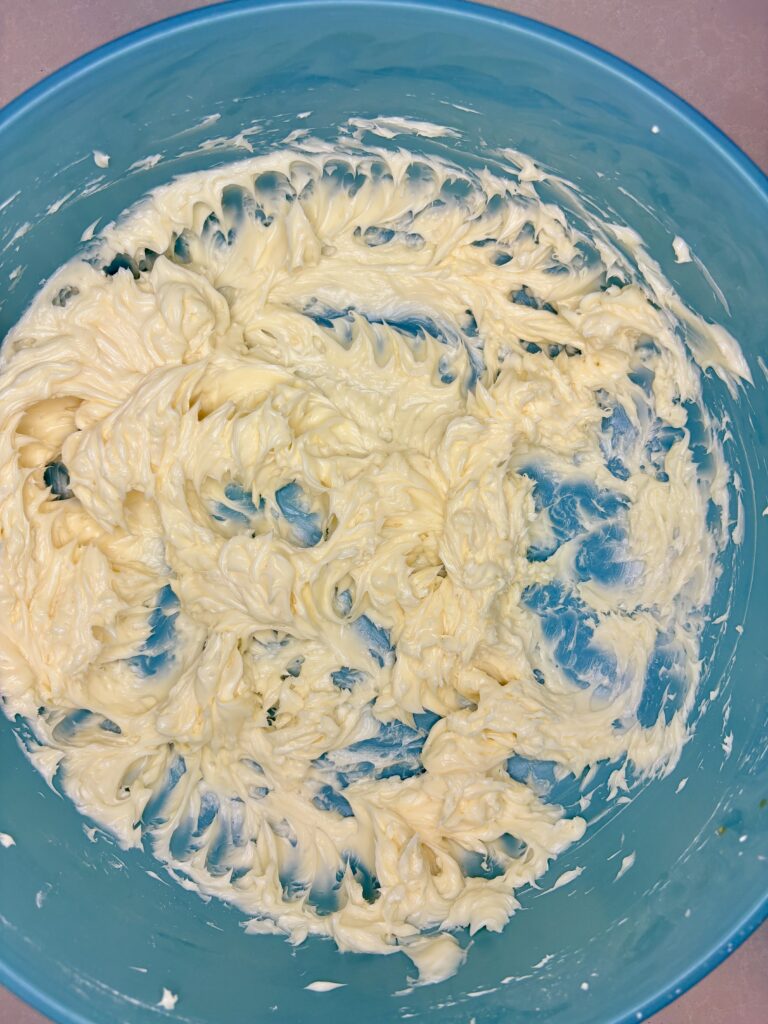 butter, powdered sugar and vanilla beaten in a bowl