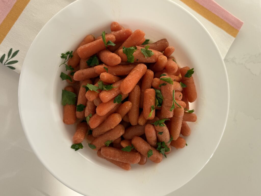 Apricot Glazed Carrots in a white bowl on the counter