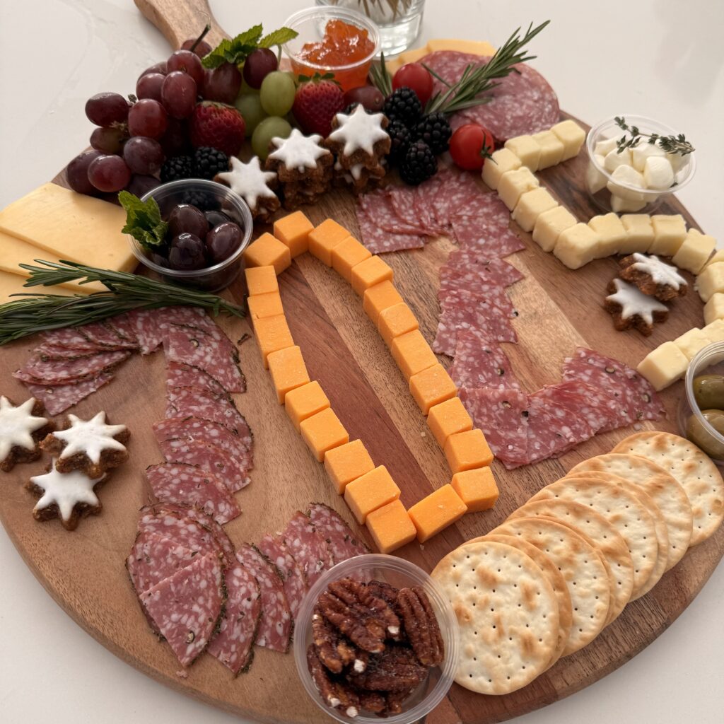 Celebration Charcuterie Board on a large brown board on the counter.