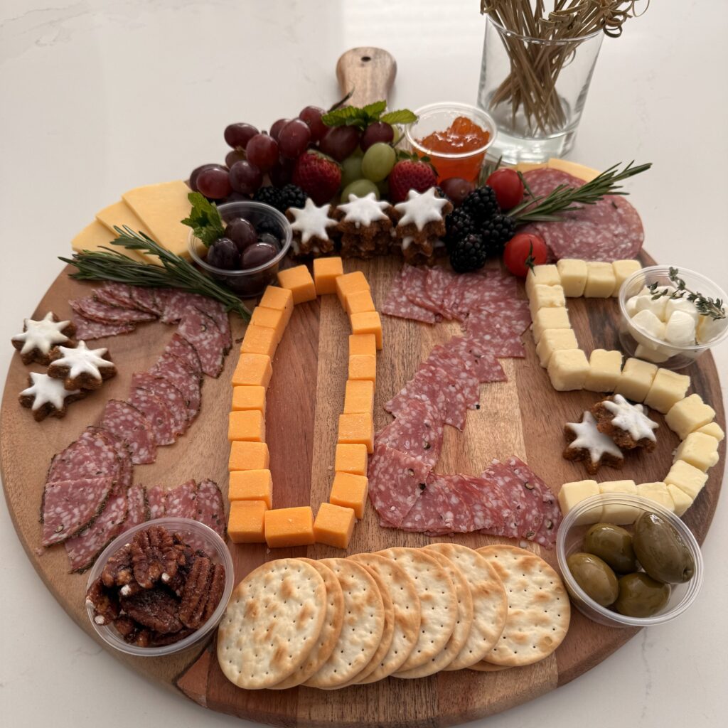 Celebration Charcuterie Board on a large brown board on the counter.