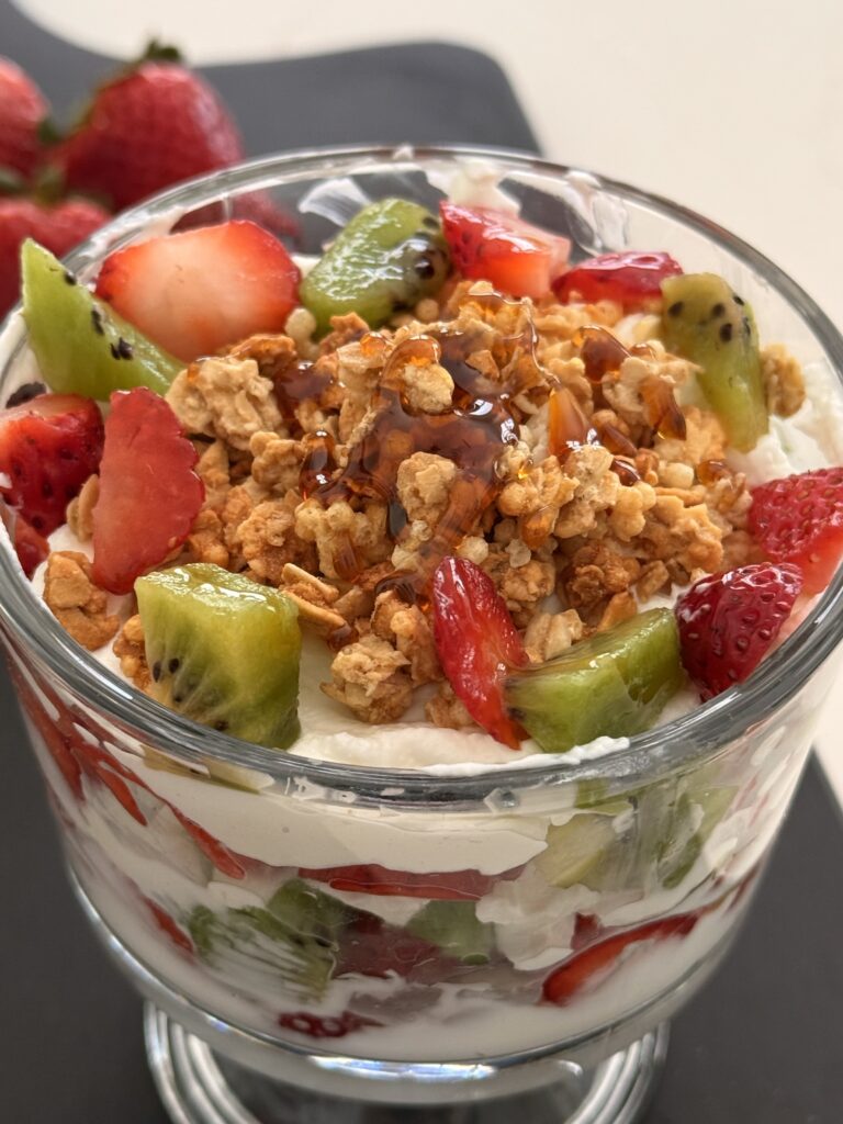 Strawberry and Kiwi Yogurt Parfait in a glass jar on the counter.