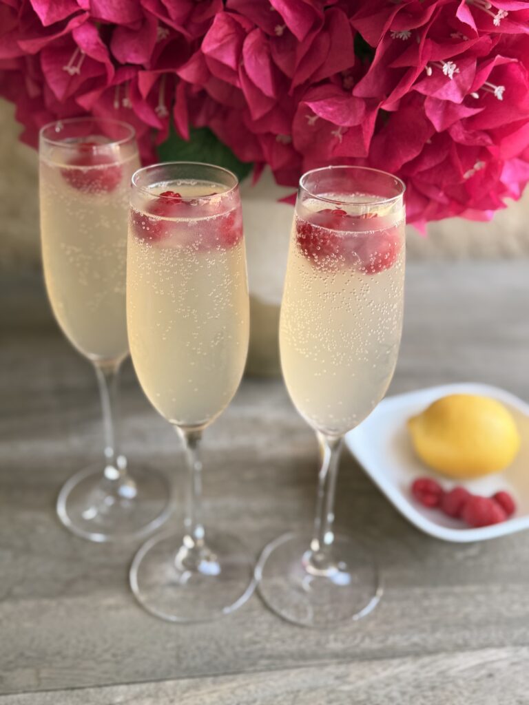 three glasses of Bubbly Berry Mocktails on a brown table.