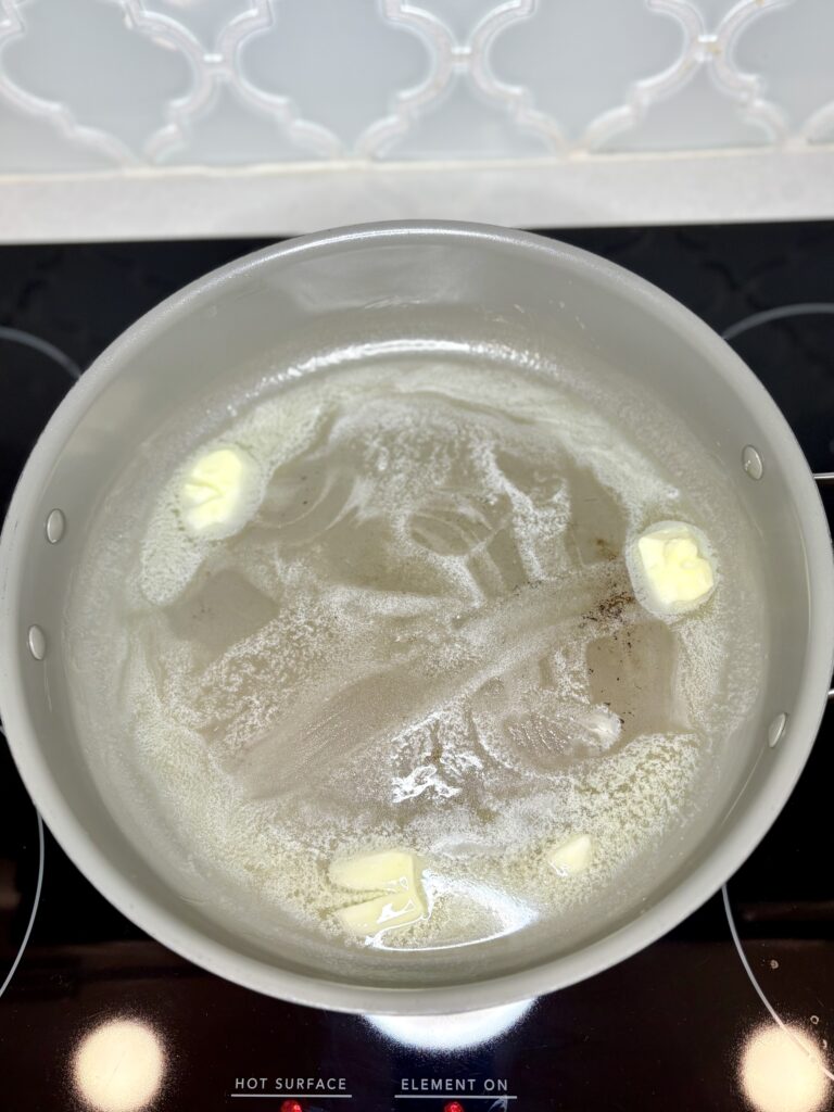 butter melting in a pan on a stove