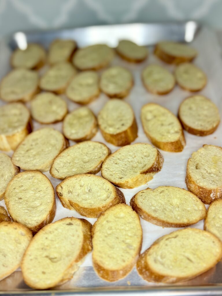 toasted crostinis on a baking sheet