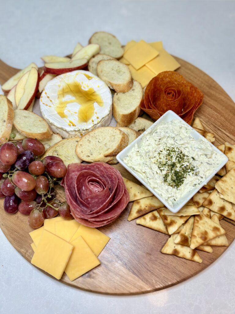 fruit, cheese slices, and pita crackers added to the board