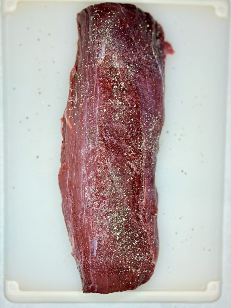 raw beef tenderloin seasoned with salt and pepper