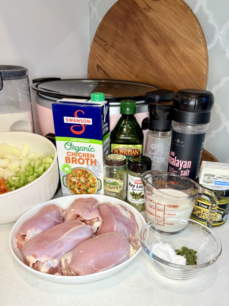 chicken thighs, vegetables, broth and seasoning on a counter