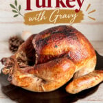 Oven roasted turkey with crispy, golden skin served on a black platter, perfect for holiday meals with gravy.