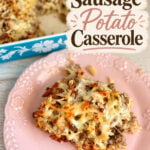 Close-up of a slice of sausage potato casserole on a pink plate with a baked casserole dish in the background.