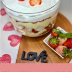 Strawberry Vanilla Trifle on a counter next to a bowl of strawberries and a heart towel