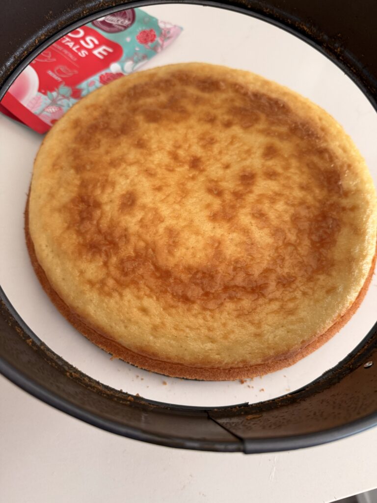 Thoroughly baked cake on the counter while the spring form is released. 