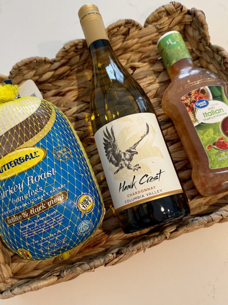 Butterball turkey roast, white wine, and Italian salad dressing in a brown wicker basket on the counter.