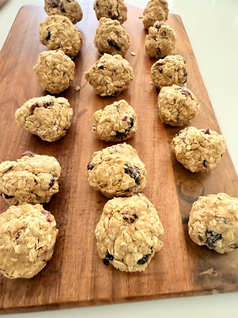 Oatmeal Raisin bites on brown cutting board on the counters.