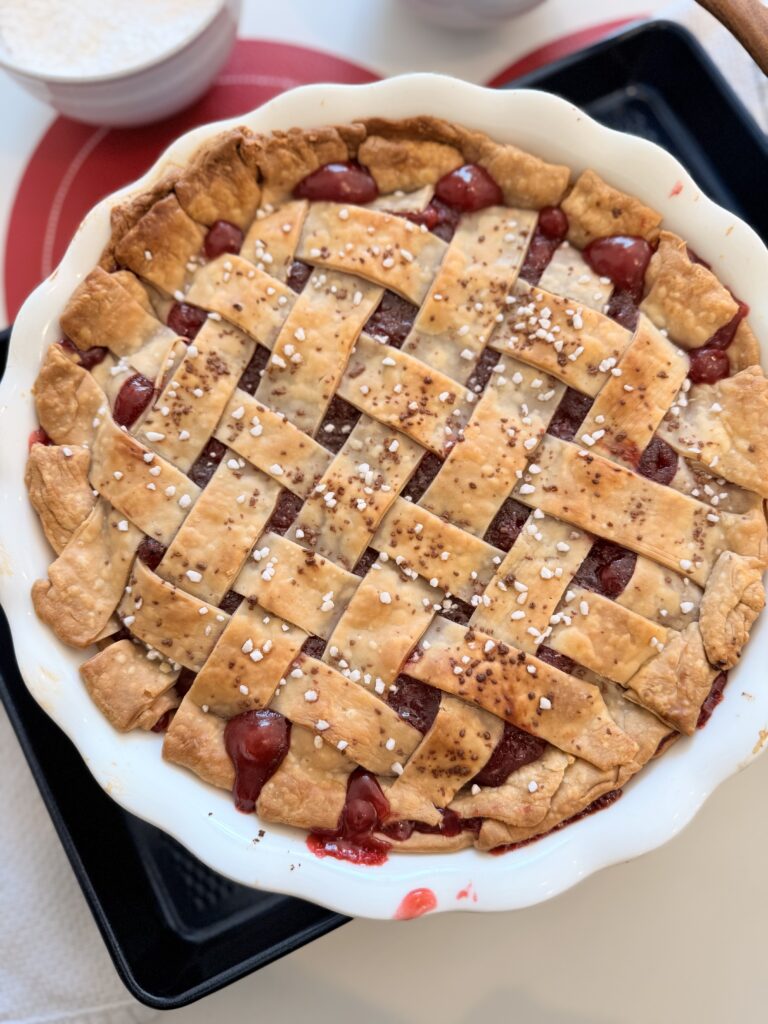 Baked Chocolate Cherry pie on a dark blue sheet pan on the counter.