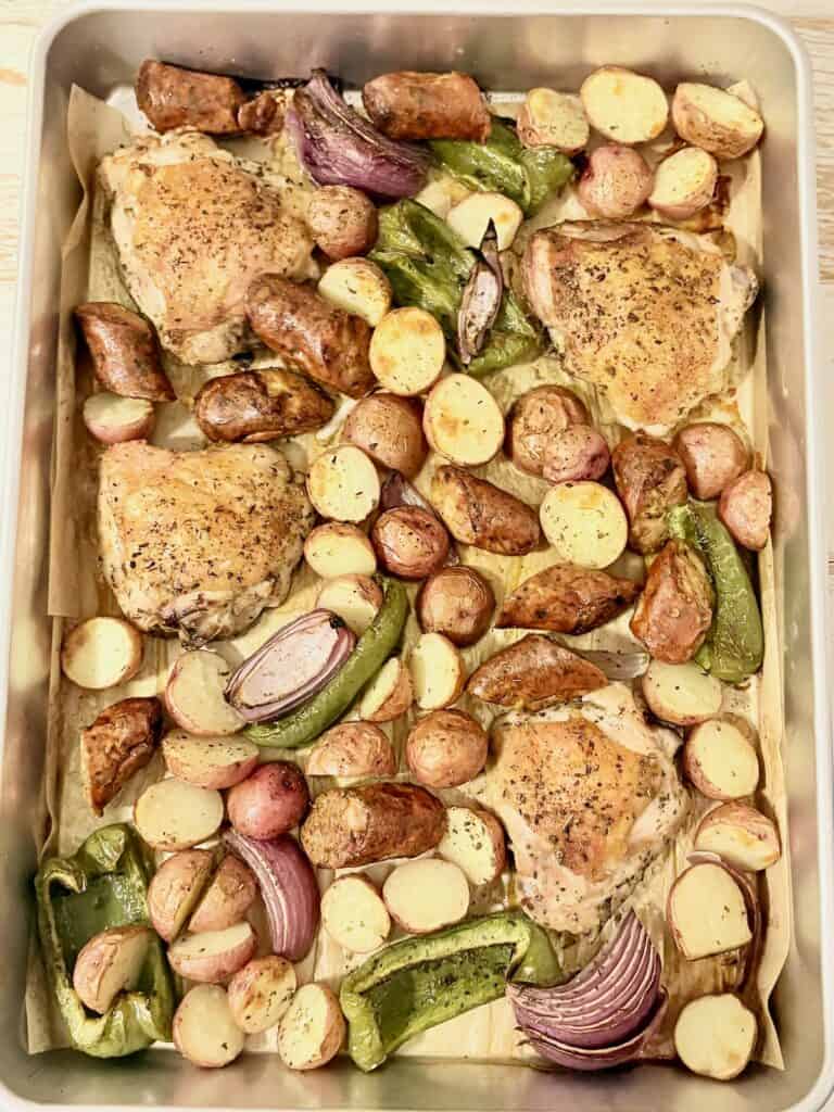 Juicy roasted chicken thighs with roasted baby potatoes, green bell peppers, and red onions baked to perfection. A simple, delicious, and wholesome meal recipe from Simply Made Dish.