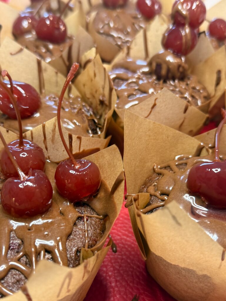 Chocolate Cherry Muffins  on a red mat on the counter.