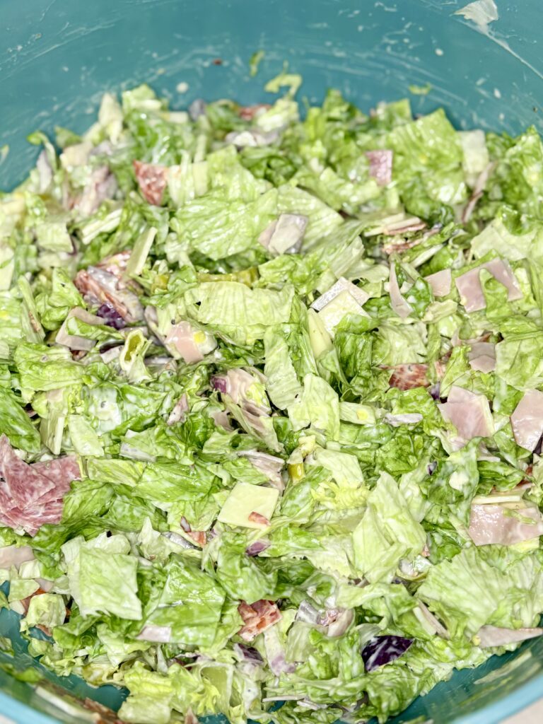 chopped antipasto salad with dressing in a bowl