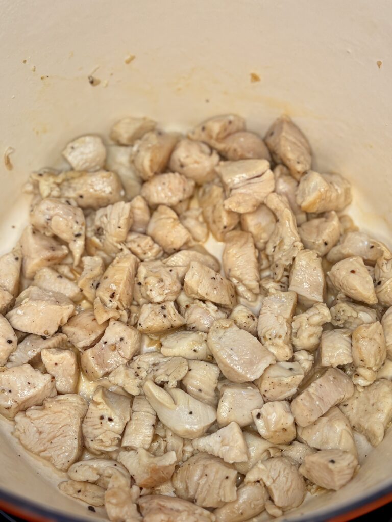 chicken chunks browning in a pot