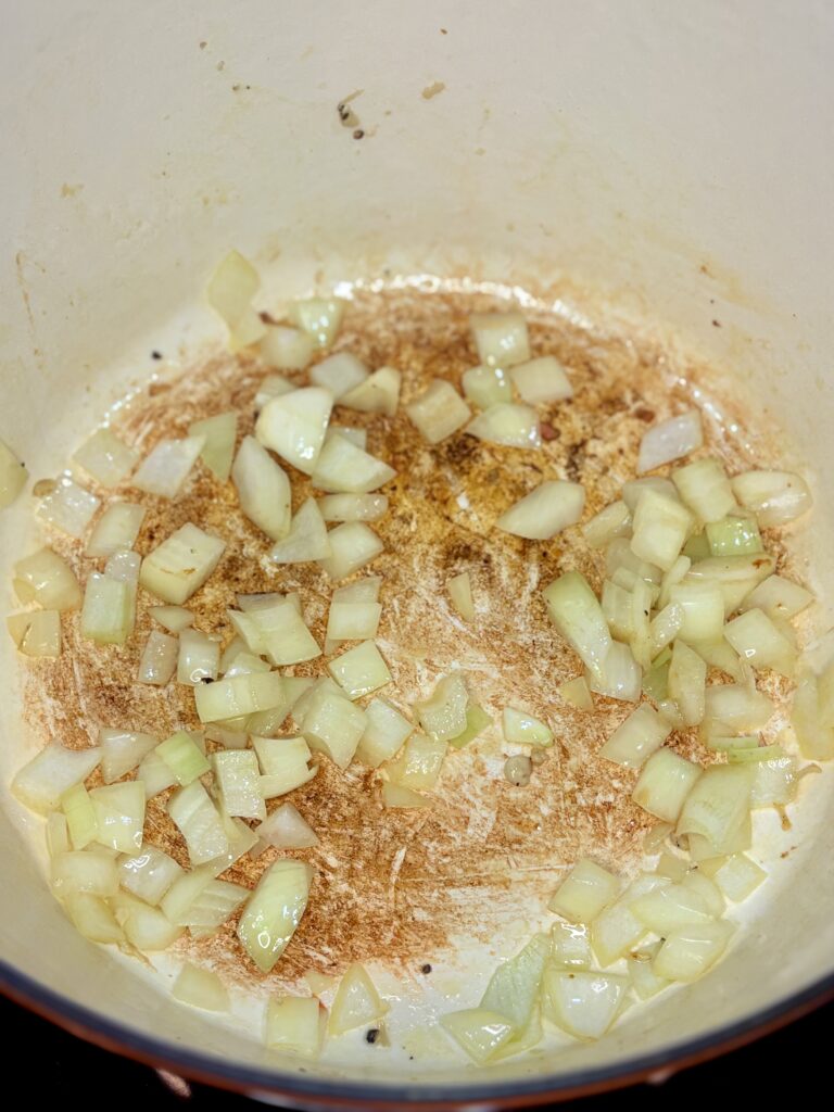 onions being browned in the pot