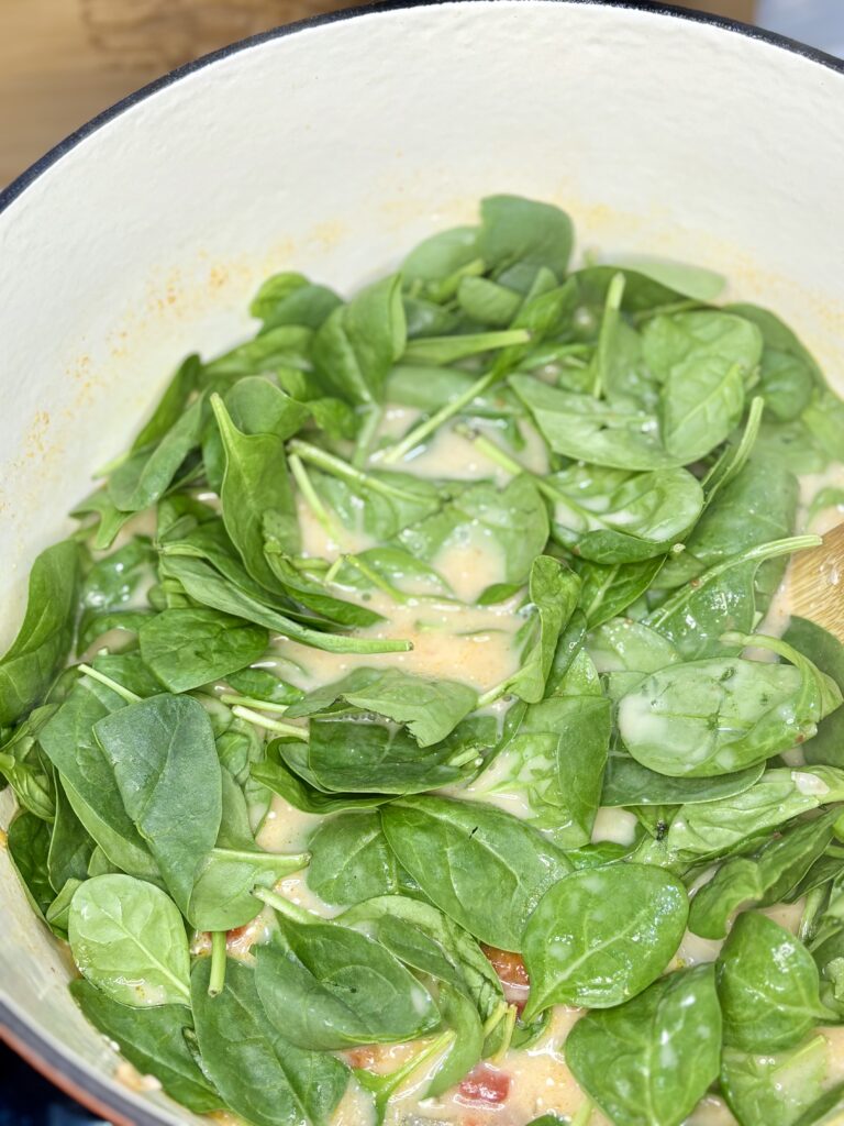 spinach added to soup pot