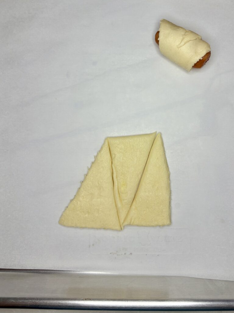 the bottom portion of a crescent roll cut into 3 triangles