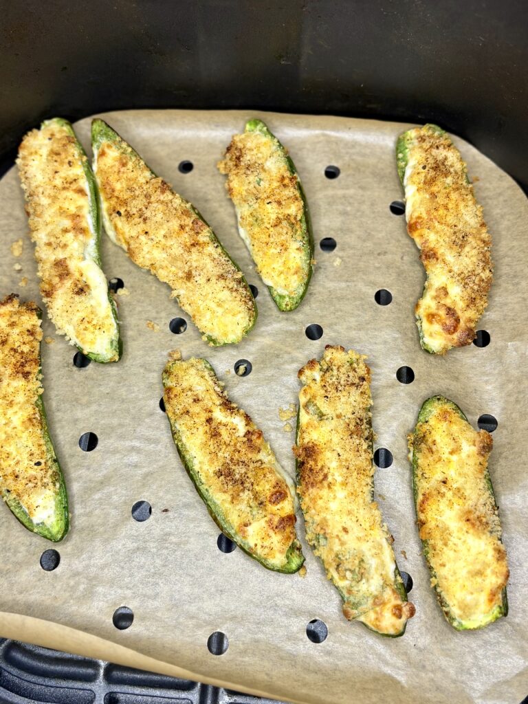 cooked jalapeño poppers in an air fryer basket