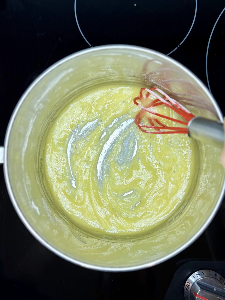 a whisk stirring the flour and butter together over medium heat