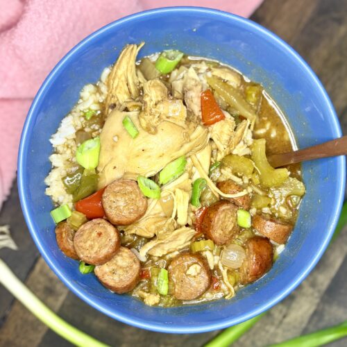 chicken gumbo in a bowl next to a towel