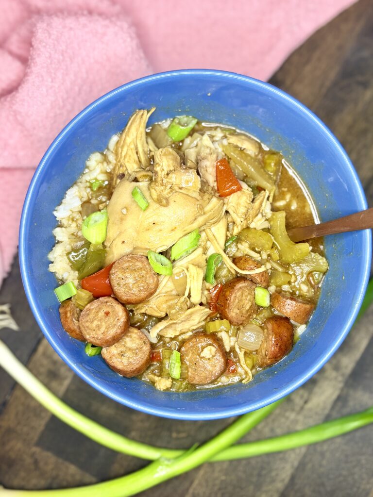 chicken gumbo in a bowl next to a towel