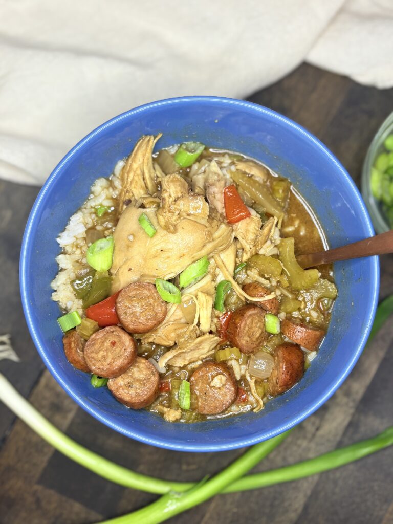 chicken gumbo in a bowl next to a towel 