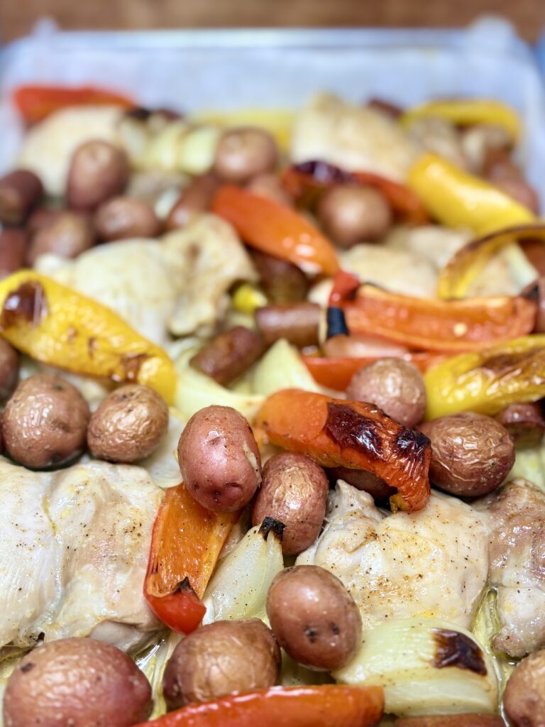 cooked chicken, sausage and vegetables on sheet pan