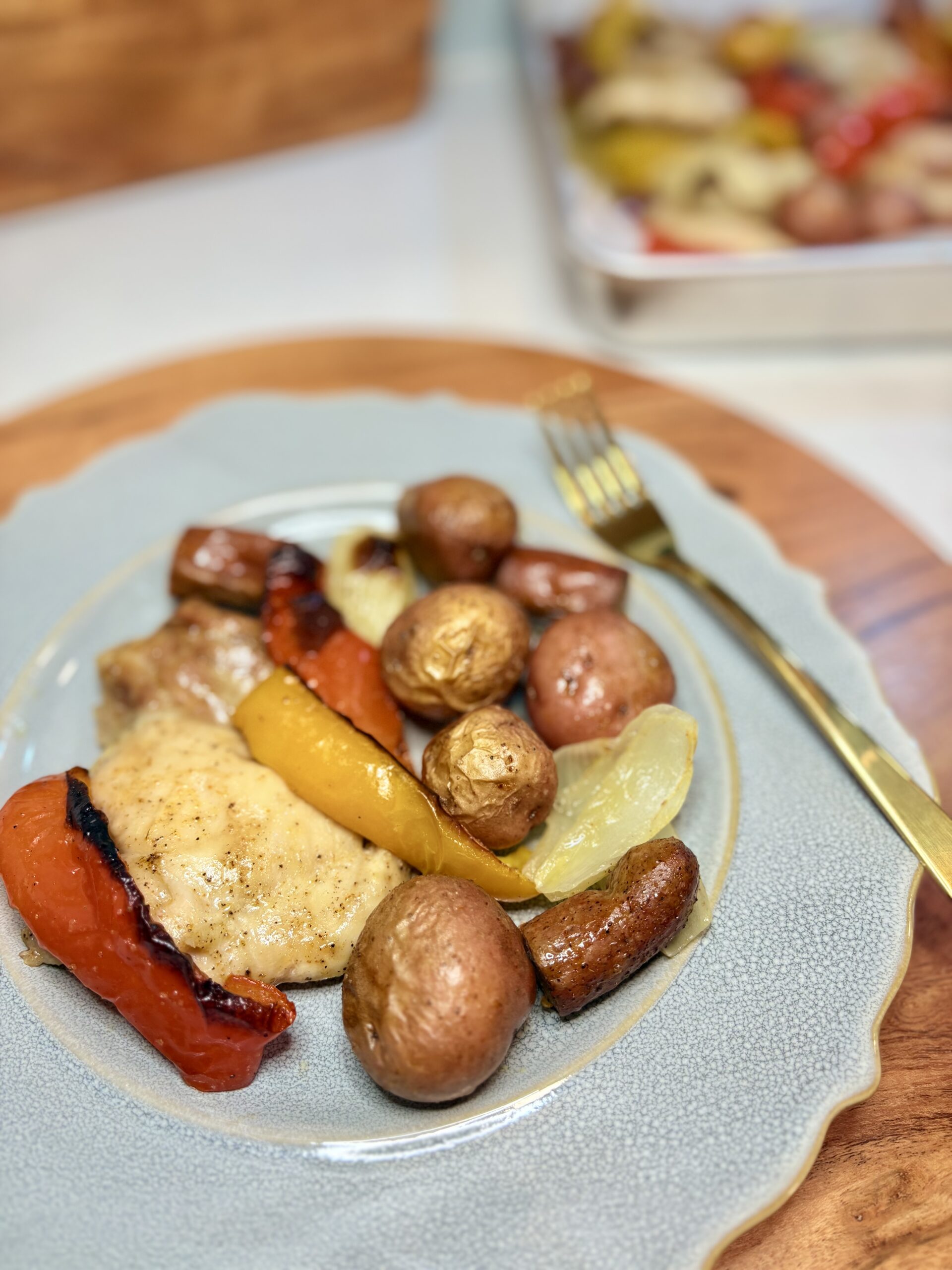 Chicken andouille sheet pan dinner on a plate on a counter