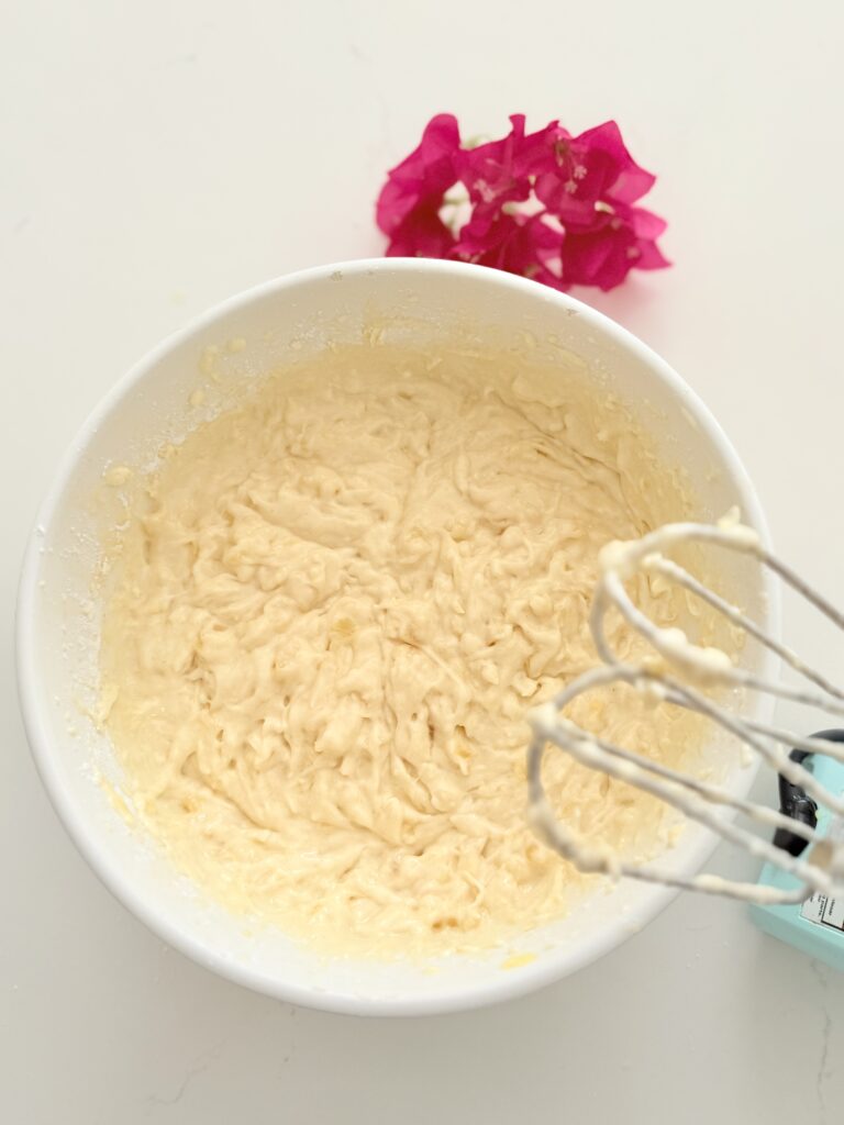 A large white mixing bowl filled with batter on the counter.