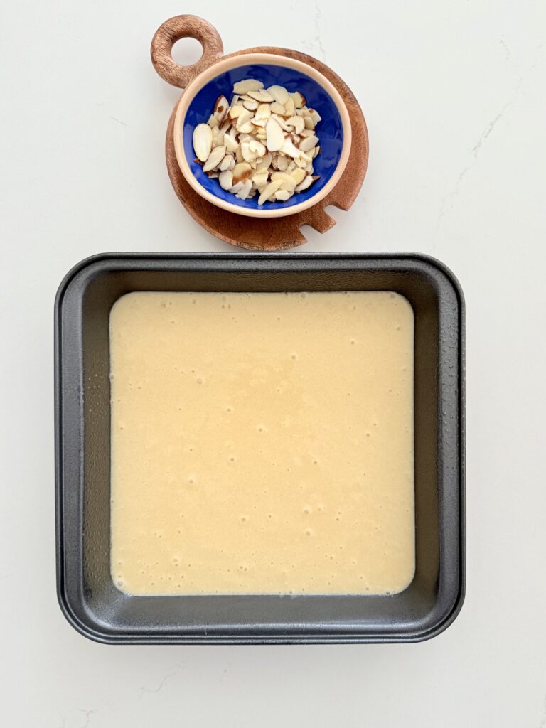 Cake batter in a cake pan on the counter.