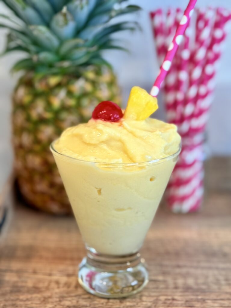 Frozen Pineapple Mocktail on a brown tray on the counter.