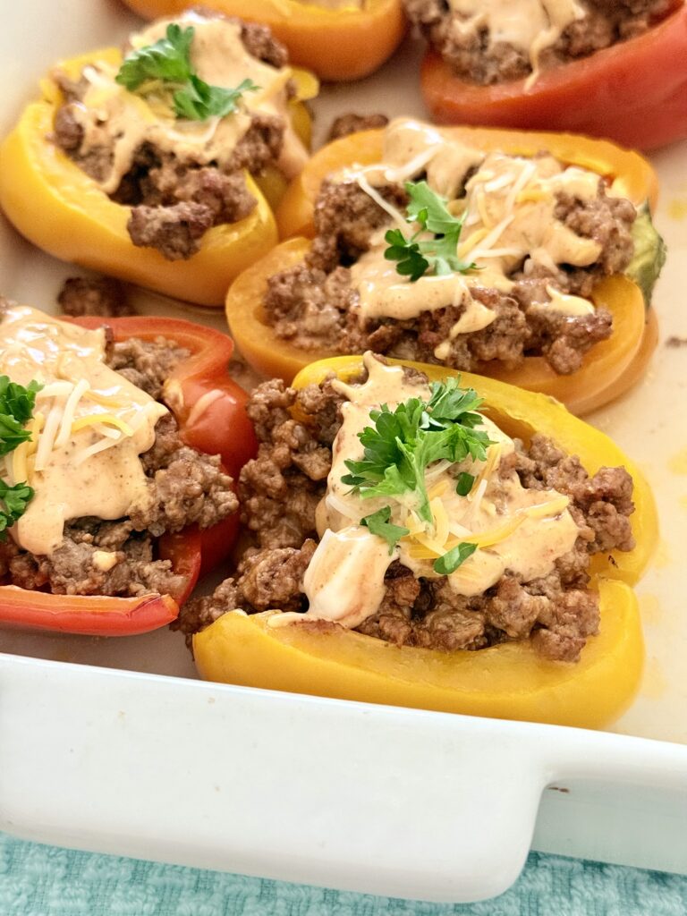 Easy Cheeseburger Stuffed Peppers in a white baking tray on a tray on the counter.