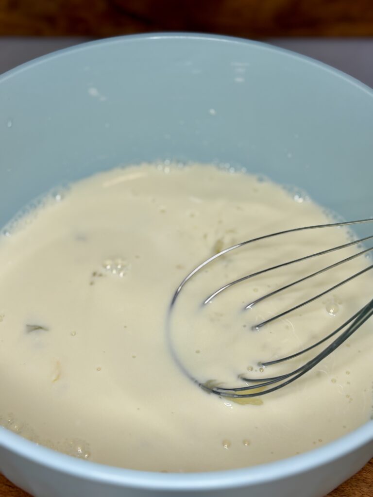 wet ingredients being whisked together in a bowl