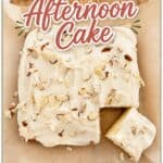 Almond afternoon cake with white icing and almond slices on top, served on parchment paper for a simple dessert.