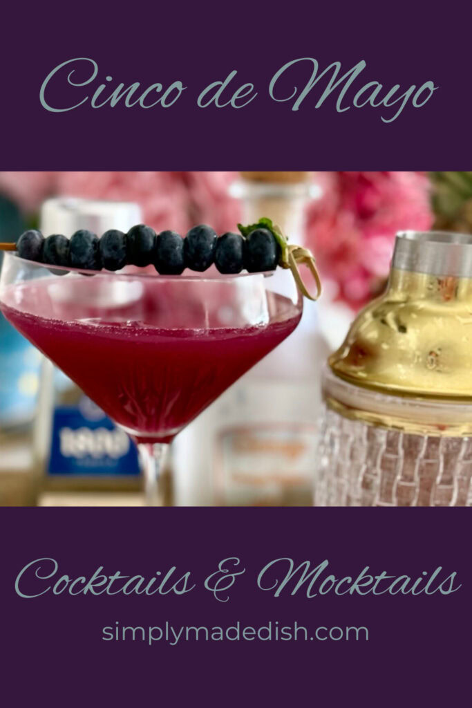 Fresh berry cocktail with blueberries on a skewer, served in a martini glass, celebrating Cinco de Mayo with colorful drinks and festive presentation.