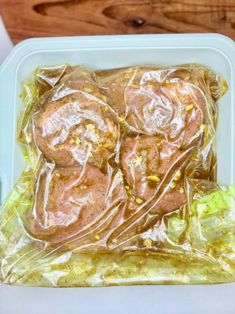 a food storage bag holding steaks and marinade